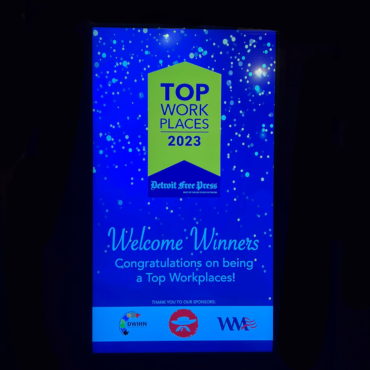 Sign at the 2023 Top Workplace Award ceremony, welcoming the winners in.